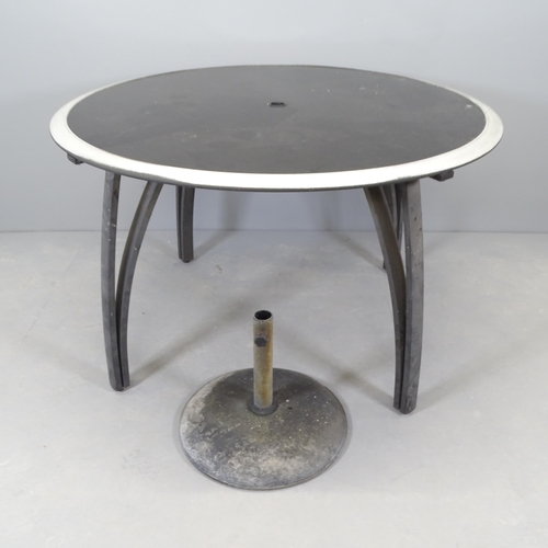 2677 - A modern circular glass topped garden table on metal frame, with parasol stand. 121x74xm