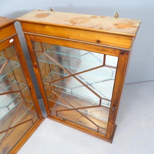 2683 - A pair of pine hanging display cabinets, with glazed panelled doors, mirror backs and three fixed gl... 