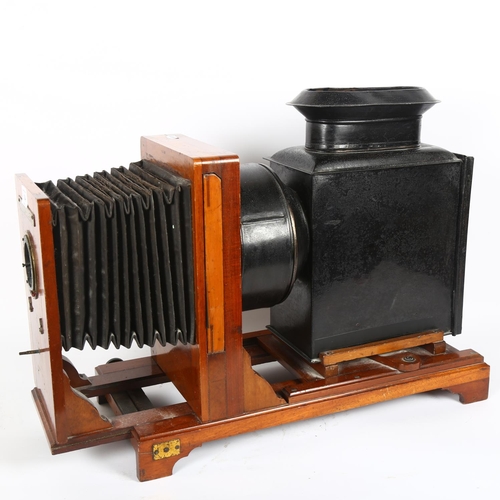 14 - An Antique magic lantern, with sliding projector and bellows, mahogany-mounted, fitted with electric... 