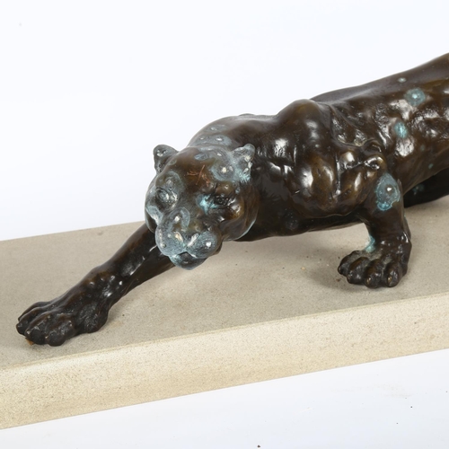 18 - A patinated resin bronze study of a prowling panther, on a stoneware stand, stand L63cm