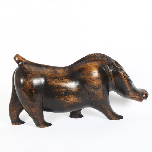 2 - An African stylised carved hardwood sculpture of a warthog, L53cm, H27cm