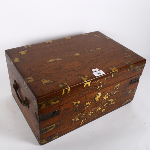 20 - An Anglo-Indian brass-bound teak travelling writing box, the rising lid revealing a fitted interior,... 