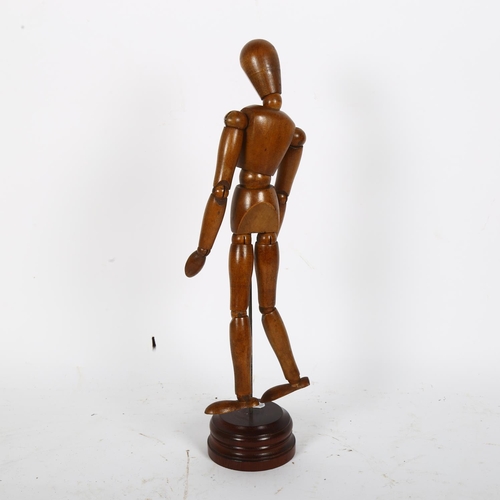 68 - An artist's lay figure of jointed form, on turned wood base, H36cm