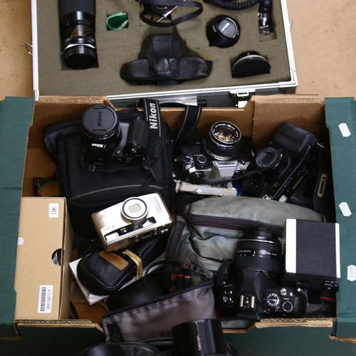 69 - A group of various cameras, including an Olympus OM2, with a Tameron tally macro lens, and 2 others,... 