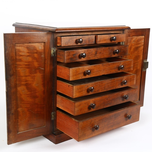 8 - A Victorian mahogany table-top collector's chest, the 2 panelled doors opening to reveal 2 short and... 