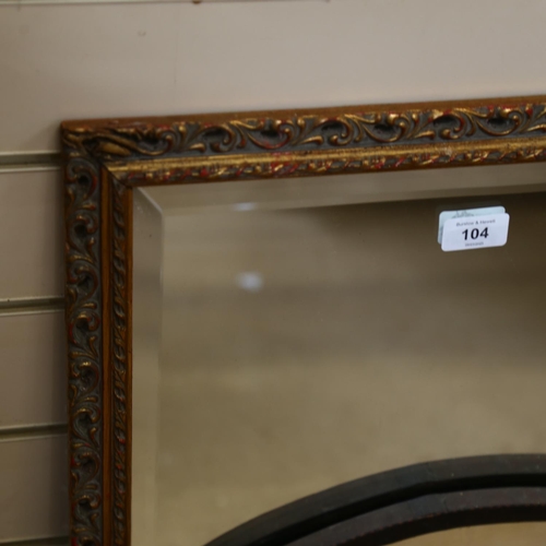 104 - A pierced gilt-framed bevel-edge wall mirror, and a mahogany-framed oval wall mirror