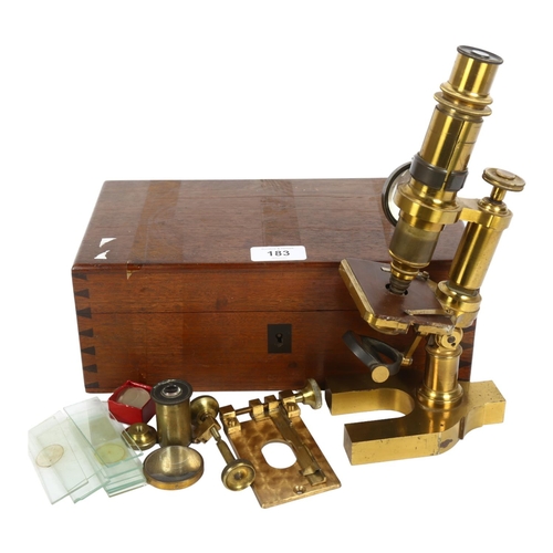 183 - A Victorian brass student's microscope, various extra lenses and some glass slides, no maker's mark,... 