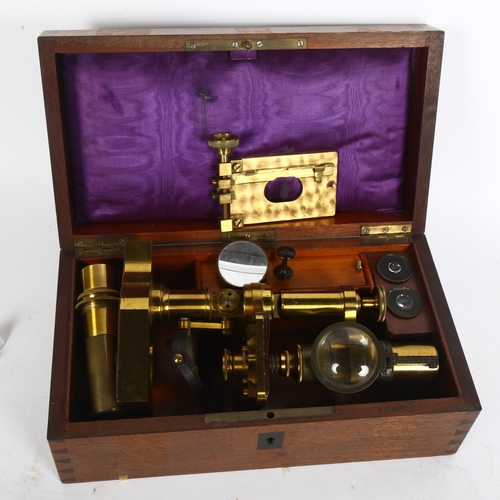 183 - A Victorian brass student's microscope, various extra lenses and some glass slides, no maker's mark,... 