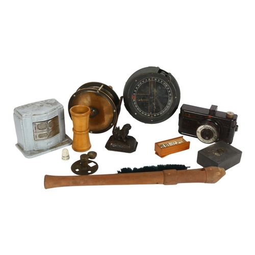 187 - A military gimballed compass, ref no. 6A1672, fishing reel, a Ciney cast-iron money box in the form ... 