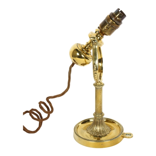 194 - A polished brass gimballed wall light, H30cm