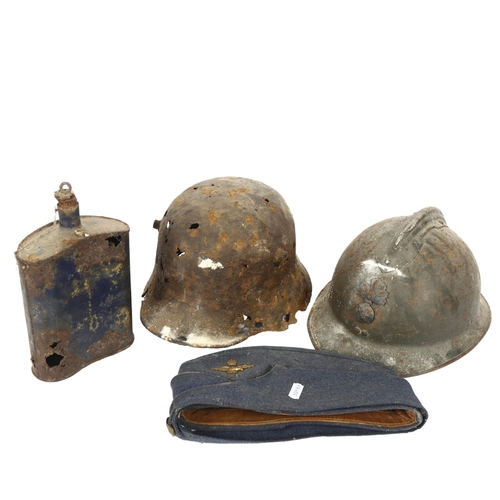 267 - A World War II French Adrian military helmet, a German military tinplate helmet, a military cobalt b... 