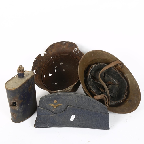 267 - A World War II French Adrian military helmet, a German military tinplate helmet, a military cobalt b... 