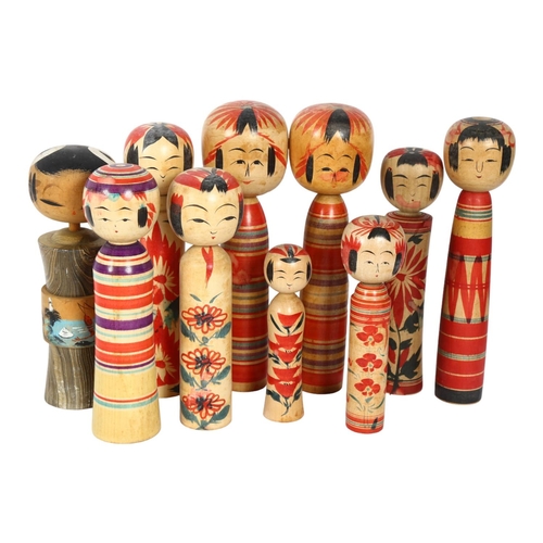 314 - 10 Oriental carved and painted wood Kokeshi dolls, tallest 21.5cm