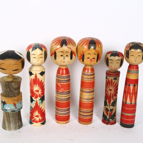 314 - 10 Oriental carved and painted wood Kokeshi dolls, tallest 21.5cm