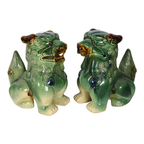 329 - A pair of painted and glazed ceramic dogs of fo, H25cm