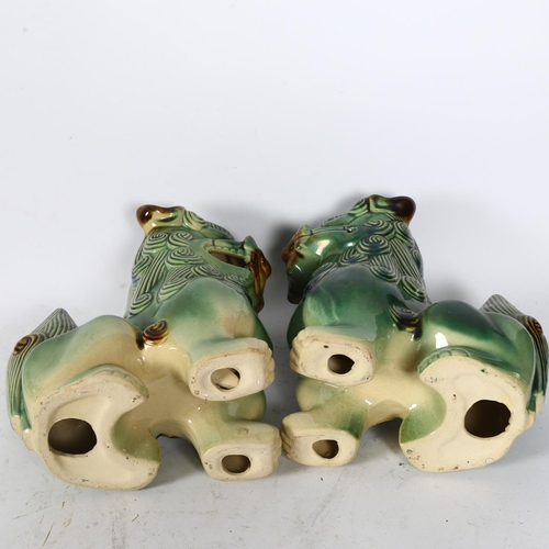 329 - A pair of painted and glazed ceramic dogs of fo, H25cm