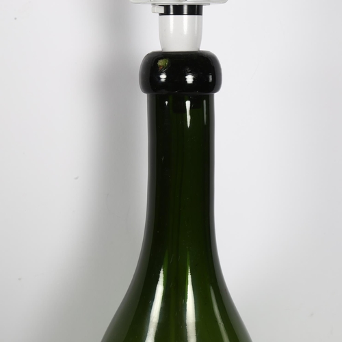 341 - A large Antique green glass bottle converted to an electric lamp, height to top of bottle 58cm