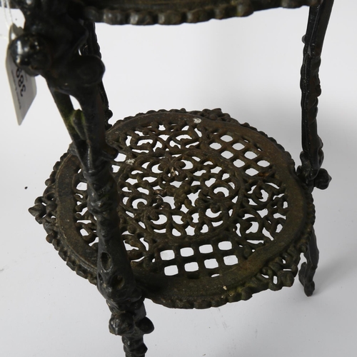 389 - A cast-iron 3-tier stand with pierced decoration, 66.5cm