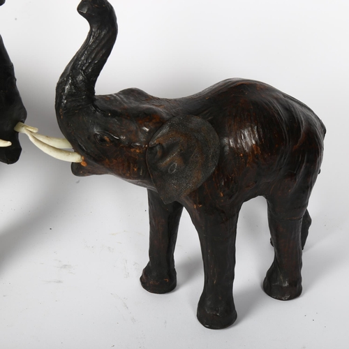 390 - A pair of carved and painted trumpeting elephants with leather ears, H35cm