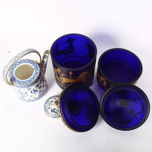 413 - Vintage porcelain tea kettle, H16cm, and 2 similar blue glass jars and covers, with gilded mythologi... 