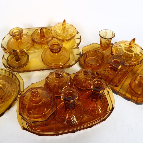 454 - 4 x 1930s amber glass dressing table trays, and various dressing table items including candlesticks ... 