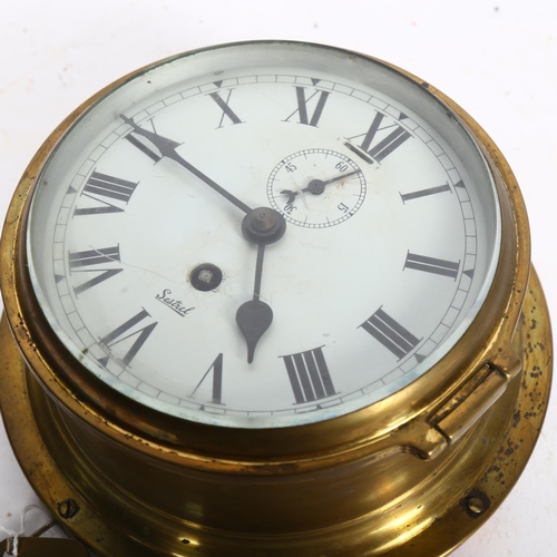 479 - A sestrel brass-cased bulkhead clock, diameter 19cm overall