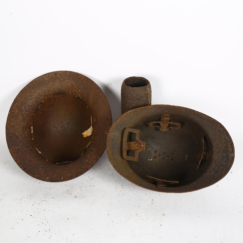 511 - A World War II French Adrian helmet, an English helmet, and a mortar shell