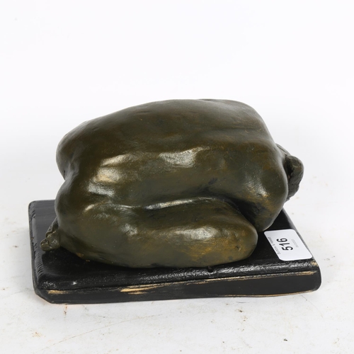 516 - A bronzed ceramic sculpture, depicting a crouching nude, on wooden plinth, L18cm