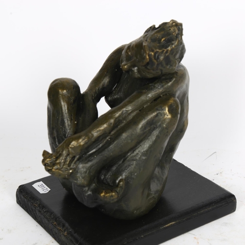 517 - A bronzed ceramic sculpture of a nude seated figure, on painted wood plinth, H23cm