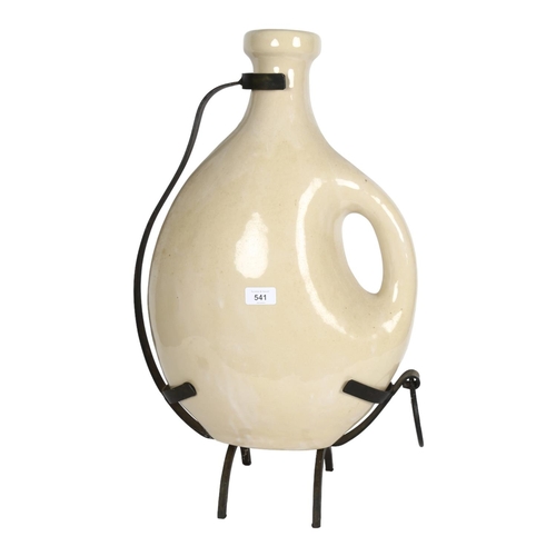 541 - A large ceramic wine jug in wrought-iron stand, H60cm