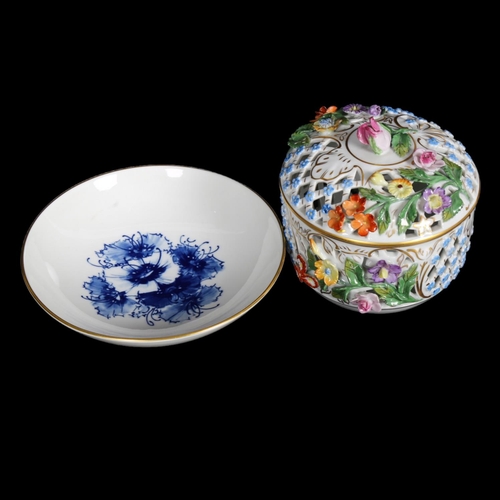 558 - A Dresden porcelain reticulated jar and cover with applied flowers, H12cm, and a Meissen shallow dis... 