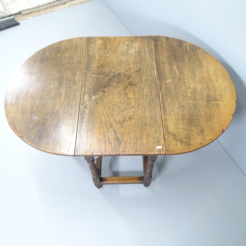 2156 - A 1920s oak oval gateleg dining table, originally retailed by Liberty's. 91x73x45cm.