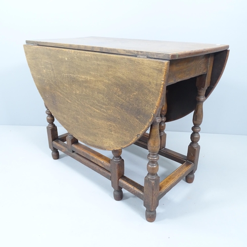 2156 - A 1920s oak oval gateleg dining table, originally retailed by Liberty's. 91x73x45cm.