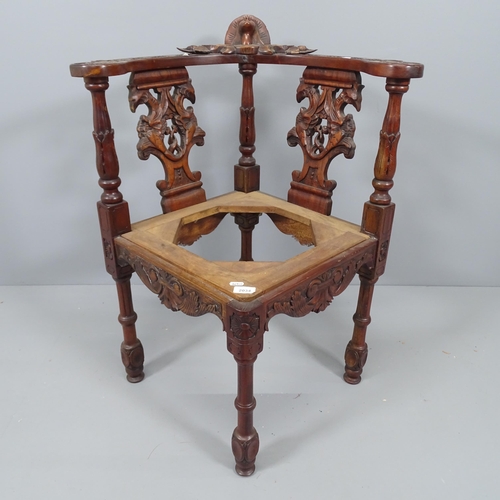 2164 - A mahogany corner armchair with carved and pierced decoration (lacking seat).