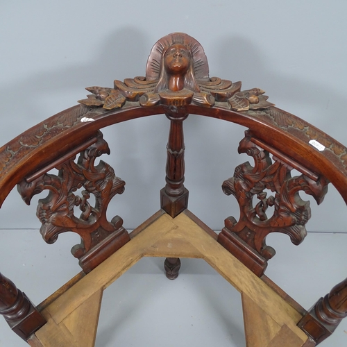 2164 - A mahogany corner armchair with carved and pierced decoration (lacking seat).