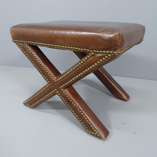 2168 - A contemporary X-frame studded leather stool. 52x42x37cm.