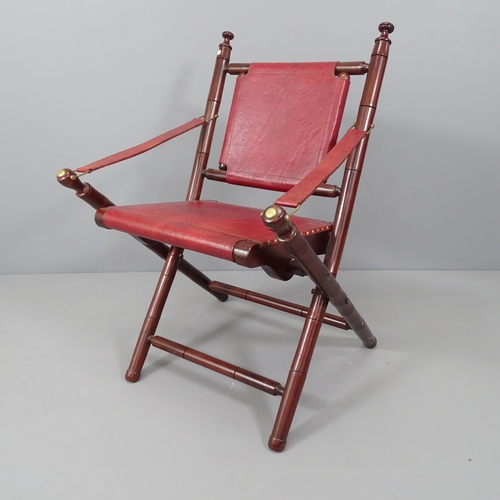 2176 - A mahogany and leather upholstered folding chair.