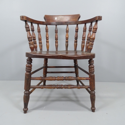 2184 - An antique elm-seated bow-arm Captain's chair.