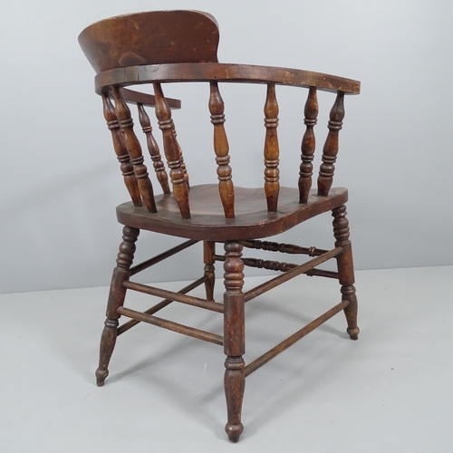 2184 - An antique elm-seated bow-arm Captain's chair.