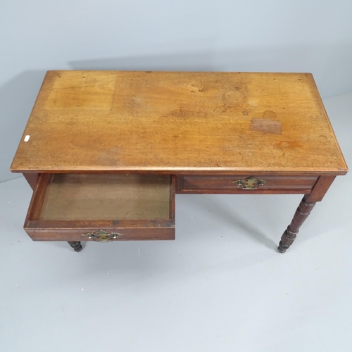 2194 - A Victorian mahogany writing table, with two drawers and raised on turned legs. 108x71x50cm