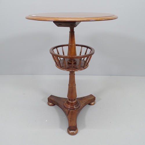 2212 - A Georgian mahogany knitting table, with rotating under-tier, with turned central column, platform b... 