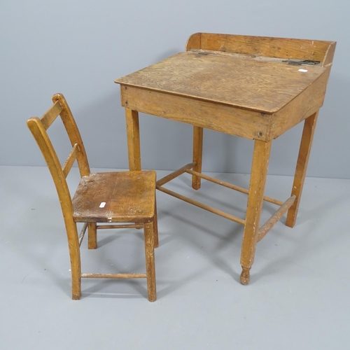 2214 - A vintage oak school desk, with label for Swallow Toys of London, 55x70x45cm, and a child's chair. (... 