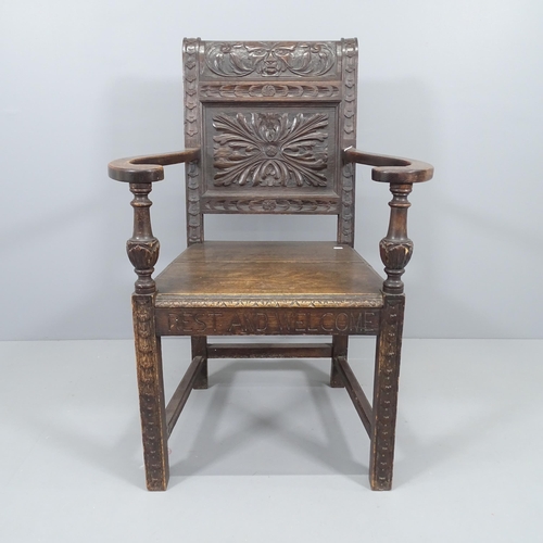 2226 - An antique oak wainscot chair, with chip carved Green Man decoration. Overall 71x105x63cm, Seat 46x4... 