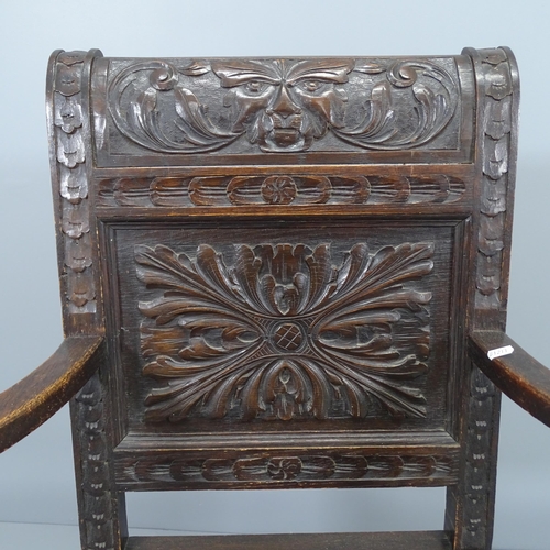 2226 - An antique oak wainscot chair, with chip carved Green Man decoration. Overall 71x105x63cm, Seat 46x4... 