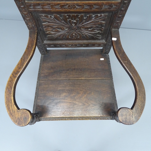 2226 - An antique oak wainscot chair, with chip carved Green Man decoration. Overall 71x105x63cm, Seat 46x4... 