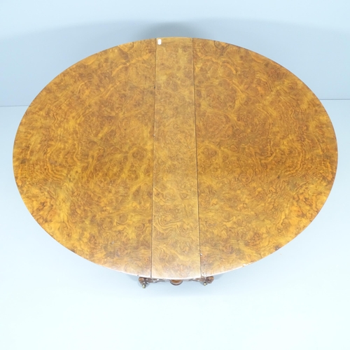 2228 - A Victorian burr walnut oval Sutherland drop-leaf table, on mahogany base. 90x72x14cm (extending to ... 