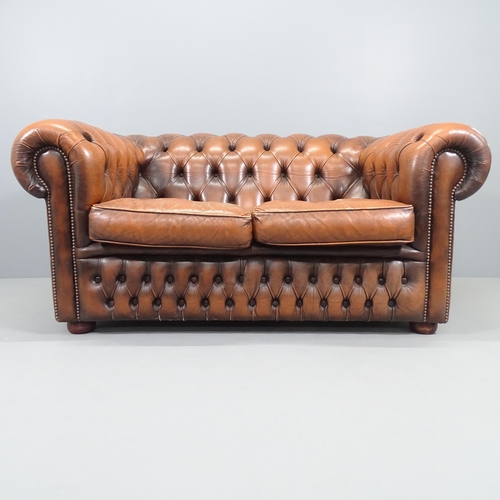 2229 - A Brown studded leather upholstered button-back Chesterfield sofa. Overall 152x72x90cm