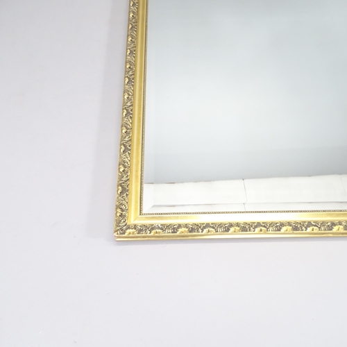 2232 - A modern gilt-framed wall mirror. 132x103cm