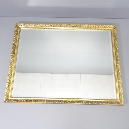 2233 - A modern gilt-framed wall mirror. 132x103cm