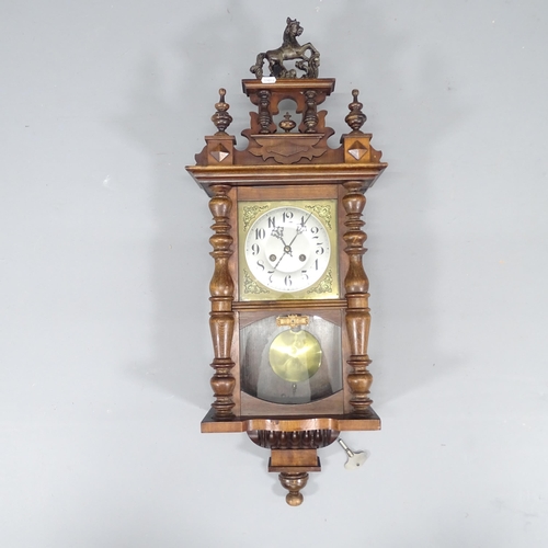 2240 - A walnut cased 8-day wall clock. Height 90cm.